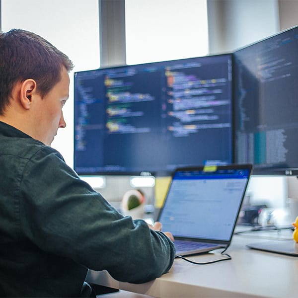 A software developer writing a code.